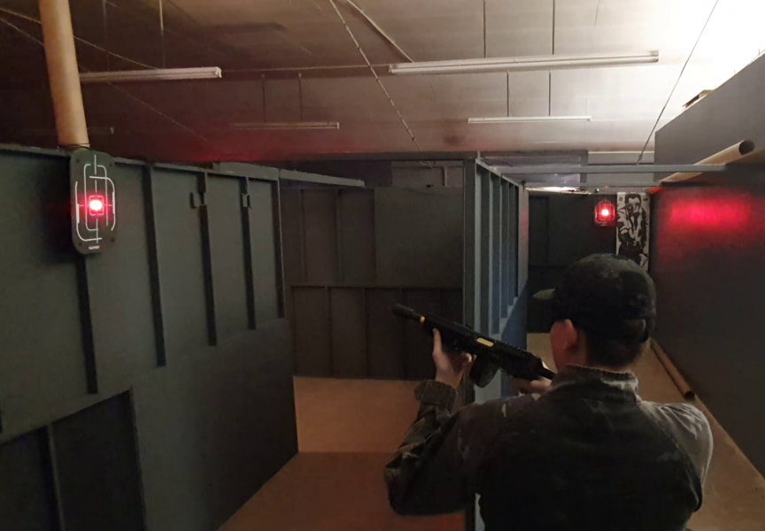 A player in a CQB shoot house running a course of fire using AttackSense digital targets